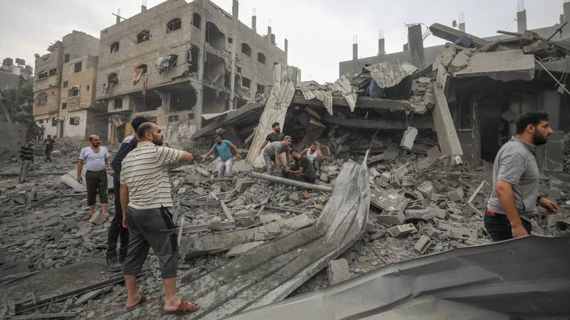 Palestinians search for survivors of Israeli aerial bombing on Jabaliya, near Gaza City,...