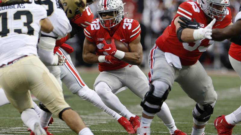Ohio State running back TreVeyon Henderson cuts up field against Purdue during the first half...