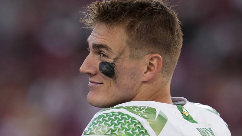 Oregon quarterback Bo Nix stands on the sideline during the second half of an NCAA college...