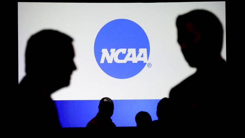 People talk after a panel discussion at the NCAA Convention Thursday, Jan. 19, 2017, in...