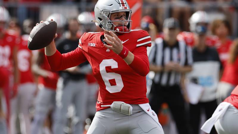 Ohio State quarterback Kyle McCord drops back to pas against Western Kentucky during the first...