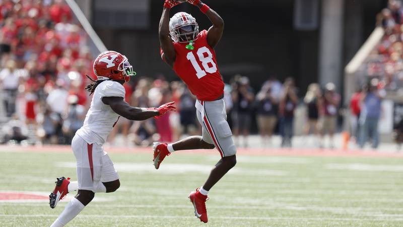Ohio State receiver Marvin Harrison, right, catches the ball in front of Youngstown State...