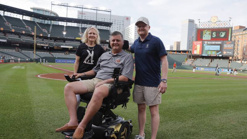 FILE - Former Baltimore Orioles pitcher Jim Poole, center, poses for a photo with his wife, Kim...
